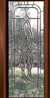 Wood-framed stained glass window panel with an ornate, interlacing leaded design and clear outer panes.