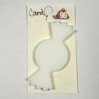 Cream-colored tag with a circular hole at the top, featuring a white bottle-shaped cut-out over the card and handwritten text that appears to say 'Candle' with a small red motif in the corner.